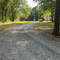 Freshly installed gravel driveway through shaded property