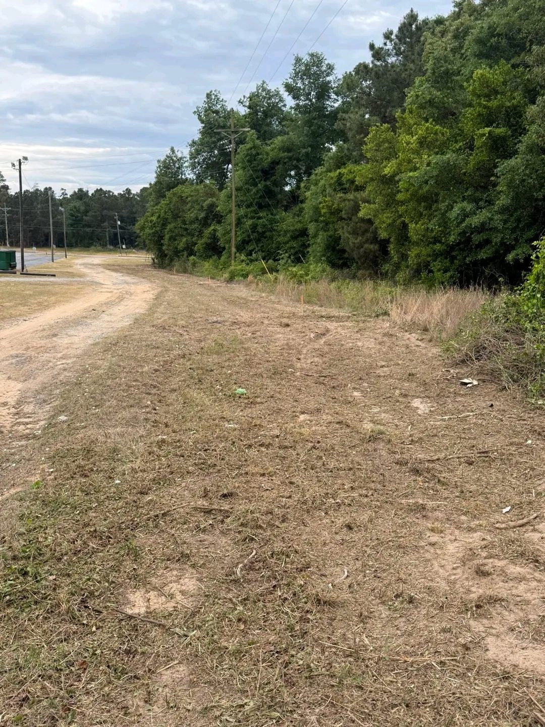 TCB Farms & Clearing land clearing project — long stretch of land cleared and leveled along a tree line